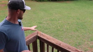 Expert pointing out deck issues—All Pro Thornton Deck Builders ensures top-notch deck repairs and replacements. Get your deck inspected today!