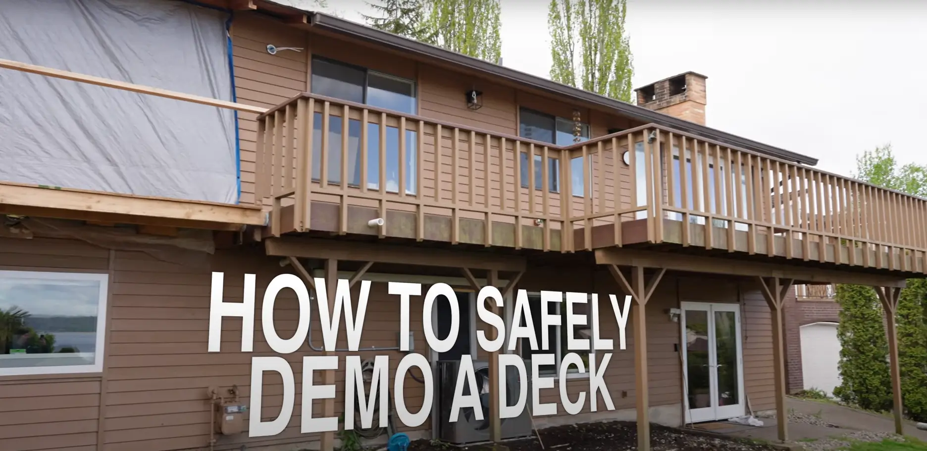 Exterior view of a house with a wooden deck and text overlay: 'How to Safely Demo a Deck.